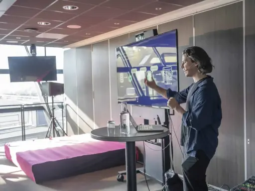 Föreläsare diskuterar hur ser framtiden ut, med en skärm som visar flöden och innehåll.