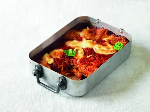 Parmigiana di melanzane ricetta originale in teglia, con pomodoro, mozzarella filante e basilico fresco.