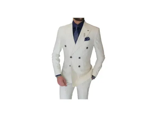 A man models a sharp double-breasted suit in white with subtle pinstripes. He wears a navy shirt and patterned tie, completing the sophisticated look.