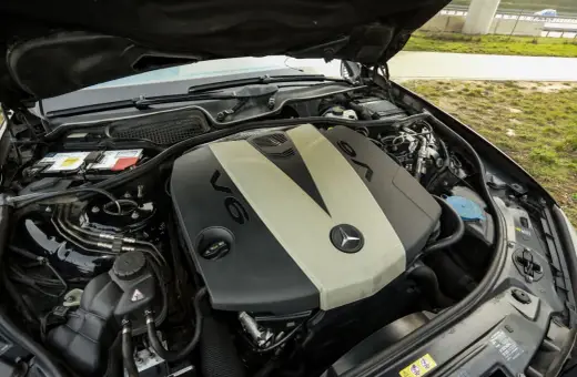 Silnik V6 om642 Mercedesa z otwartą maską. Widoczny akumulator, płyny i elementy osprzętu.