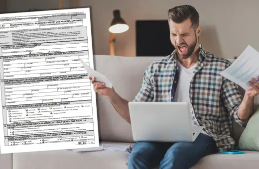 Mężczyzna z wściekłą miną trzyma dokumenty i laptopa, próbując zrozumieć formularz SD-Z2.