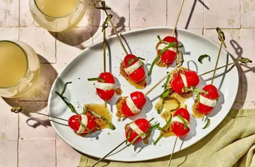 Proste przepisy na przekąski w 15 minut: szaszłyki caprese na chrupkim pieczywie z bazylią i sosem.