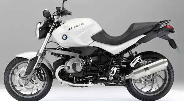 Biały motocykl BMW R1200R z czarnym siedzeniem, gotowy do jazdy.