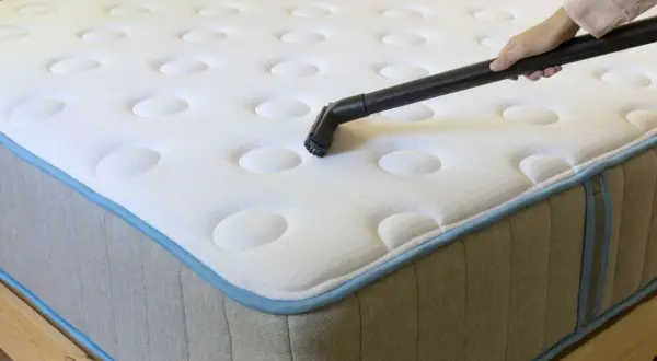 Vacuuming mattresses to remove dust mites and allergens.