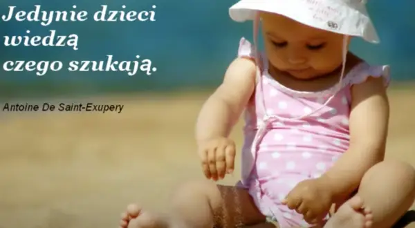 Małe dziecko w różowym stroju kąpielowym i kapeluszu siedzi na plaży. Cytat: "Jedynie dzieci wiedzą czego szukają.