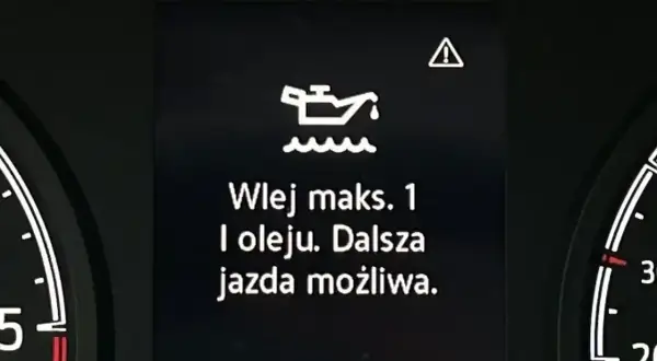 Kontrolka silnika z ikoną oleju i tekstem "Wlej maks. 1 l oleju. Dalsza jazda możliwa." - objawy za gęsty olej w silniku.