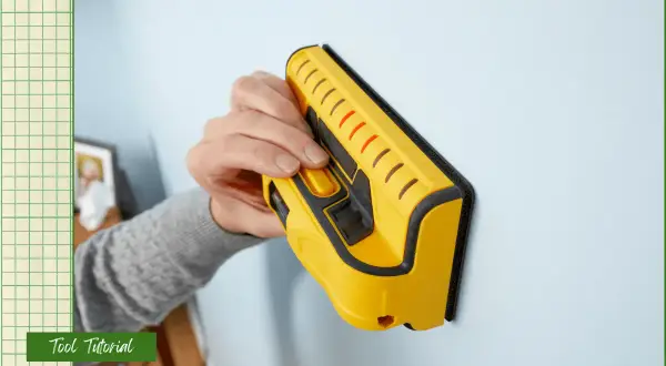 Learn how to use a stud finder to locate wall studs for secure mounting. This yellow tool is pressed against the wall.