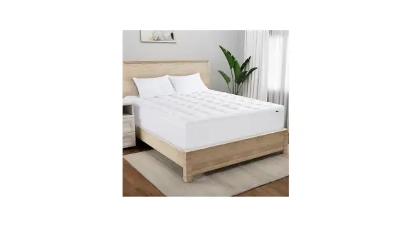 A Serta mattress topper on a bed. Wondering how long does a Serta mattress take to expand? This topper is ready for sleep.