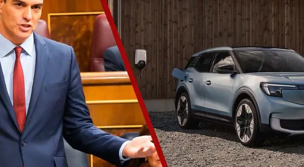 Pedro Sánchez en el Congreso, mientras un coche eléctrico espera su turno en la lista de espera del plan moves iii.