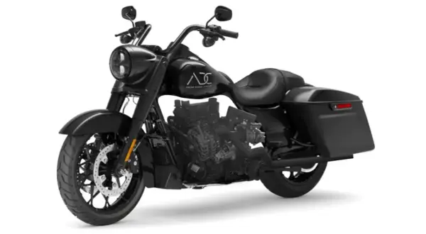 Una moto diesel negra, estilo bagger, con motor expuesto y alforjas.