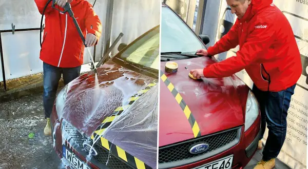 Mężczyzna myje i woskuje samochód na myjni bezdotykowej. Najpierw spłukuje auto pianą, a potem nakłada wosk.