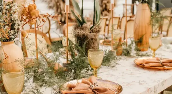 Elegancko nakryty stół weselny z rustykalnymi dodatkami. Zastanawiasz się, ile kosztuje catering na wesele?
