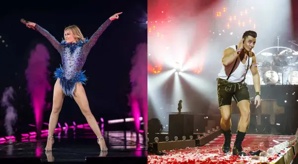 Helene Fischer und ein Mann in Lederhosen auf Bühne. Deutsche Lieder, die jeder kennt, werden hier gefeiert.