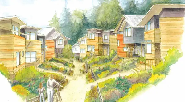 Esempi di cohousing: case moderne immerse nel verde, con sentieri e persone che passeggiano.