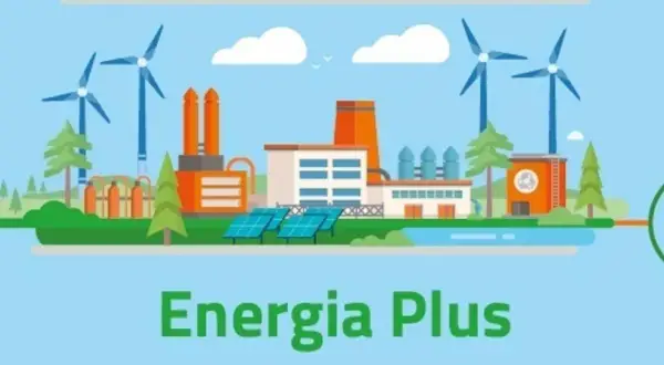 Ilustracja przedstawia nowoczesną fabrykę z turbinami wiatrowymi i panelami słonecznymi, symbolizującą program Energia Plus i ekologiczne rozwiązania.