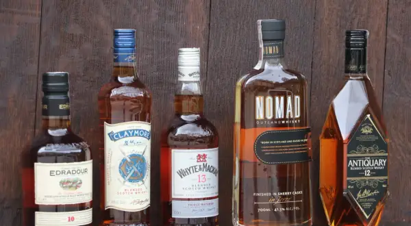 Pięć butelek szkockiej whisky, w tym Edradour 10, Claymore, Whyte & Mackay 13, Nomad i Antiquary 12. Nomad ma 41,3% alkoholu.