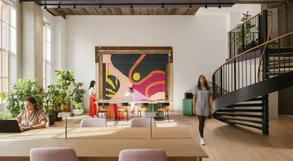 Vibrant mural and spiral staircase showcase current design trends in this modern workspace.