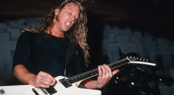 James Hetfield z Metalliki gra na białej gitarze typu Flying V.