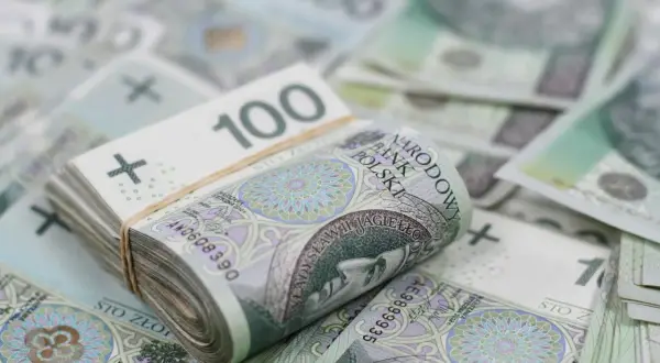 Stos banknotów 100 zł, symbolizujący bezpieczne inwestowanie.