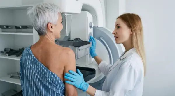 Lekarka przygotowuje pacjentkę do mammografii. Czy mammografia boli? To badanie jest ważne dla zdrowia.