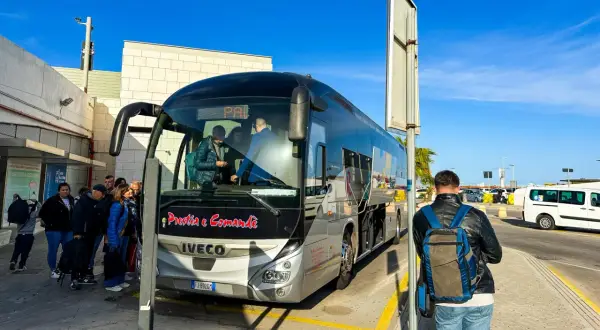 Dojazd z lotniska do Palermo autobusem Prestia e Comandè. Grupa ludzi czeka na odjazd.