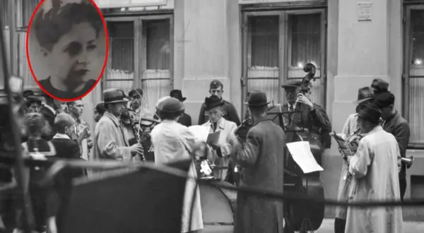 Kobieta w okręgu, zespół grający na ulicy. Muzycy z instrumentami, jakby po pracy, jak siekiera motyka, w tle budynek.