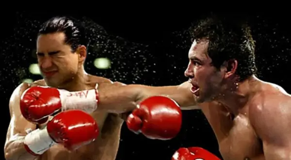 Mario Lopez in a boxing match, caught mid-punch as sweat flies.