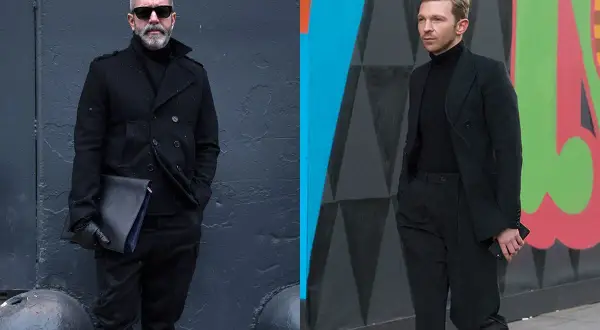 Zwei Männer in elegantem schwarzem Anzug und schwarzem Hemd. Der eine trägt einen Mantel, der andere einen Blazer.