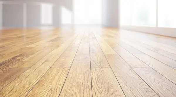 Pavimento in legno massiccio, con venature naturali che riflettono la luce. Un ambiente luminoso e accogliente.
