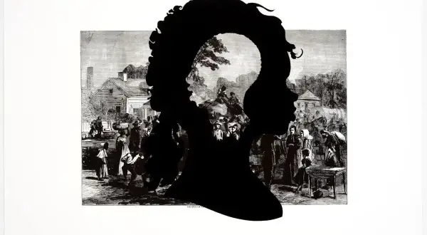 Kara Walker artwork: Black silhouettes of two profiles, one nested within the other, overlay a historical engraving of a bustling village scene with figures and buildings.