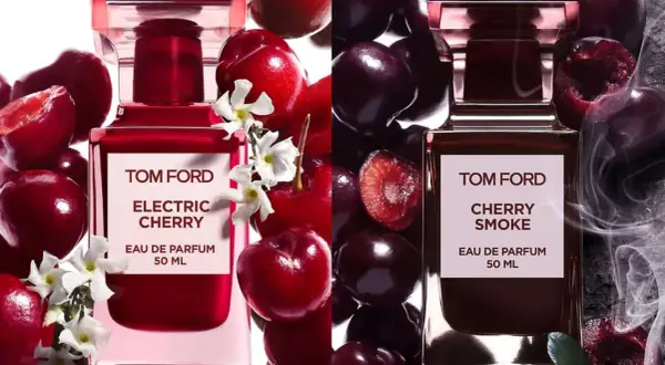 Dwa flakony perfum Tom Ford: Electric Cherry z białymi kwiatami i świeżymi wiśniami, oraz Cherry Smoke z dymem i ciemnymi wiśniami.