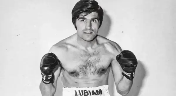 Boxer Nino Benvenuti, a powerful figure with boxing gloves on, ready to fight.