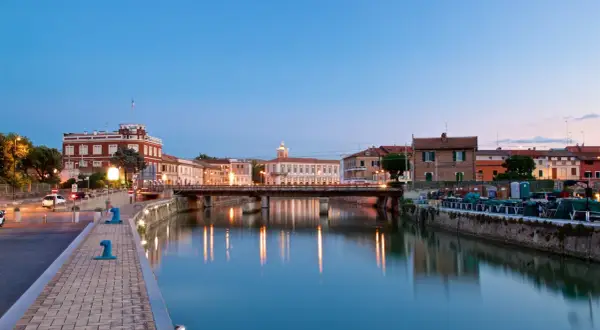 Canale di Senigallia al tramonto, con riflessi sull'acqua e palazzi storici. La fiera senigallia è un evento che anima questa splendida città.