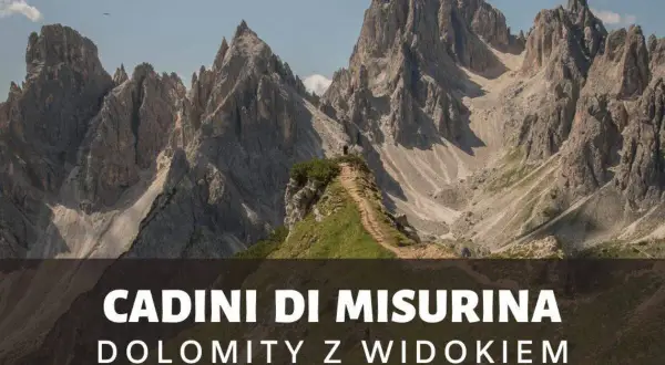 Majestatyczne szczyty Cadini di Misurina w Dolomitach, z wąską ścieżką prowadzącą na zielony pagórek.