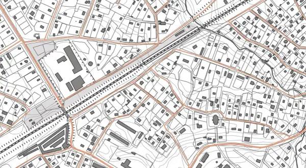 Szczegółowa mapa sytuacyjno wysokościowa z zaznaczonymi budynkami, drogami i liniami kolejowymi.