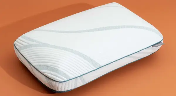 A white memory foam pillow with blue trim and a textured pattern. Learn how to expand memory foam pillow for ultimate comfort.