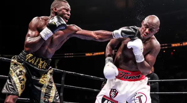 Two boxers exchange blows in the ring. The boxer on the left lands a punch, while the boxer on the right braces for impact. This intense fight showcases the power and skill involved in boxing, where weight classes like cruiserweight define the competit...