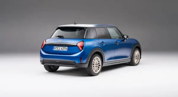 Niebieski Mini Cooper z białym dachem, widok z tyłu. Sprawdź aktualną mini cooper cena i dostępne wersje.