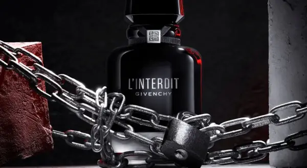 L'Interdit Intense Givenchy, zamknięty w łańcuchach i kłódce, symbolizuje zakazaną, intensywną moc zapachu.