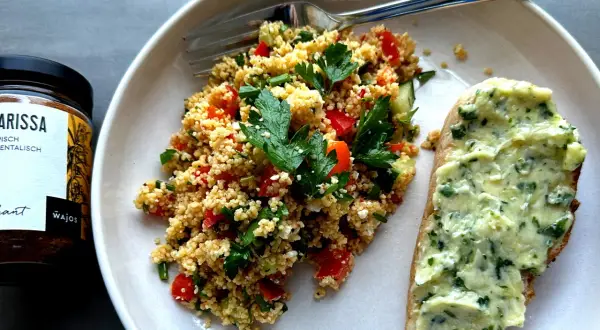 Frischer Couscous-Salat mit Tomaten, Gurken und Kräutern, serviert mit Kräuterbutterbrot. Ein tolles Couscous-Salat-Rezept für den Sommer.