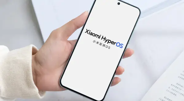 Dłoń trzyma smartfon z logo Xiaomi HyperOS. Nowy system operacyjny zapowiada rewolucję.