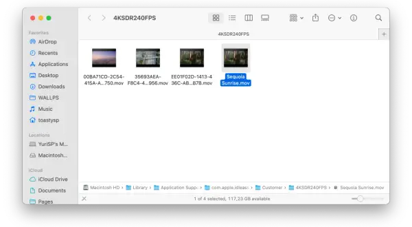 Widok folderu z plikami wideo, w tym "Sequoia Sunrise.mov". Możesz tu znaleźć inspirację, jak zmienić tapetę na laptopie.