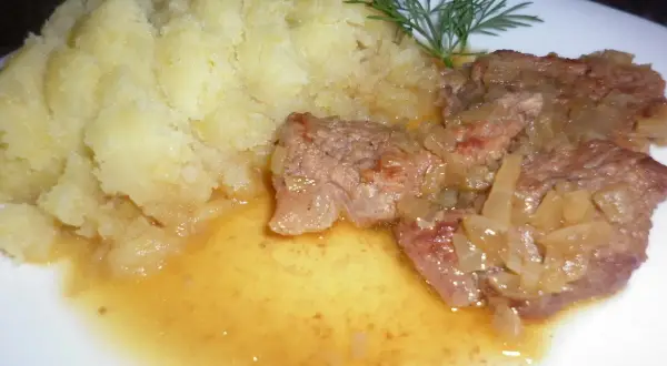 Pyszna cielęcina duszona w sosie własnym z puree ziemniaczanym i gałązką koperku.