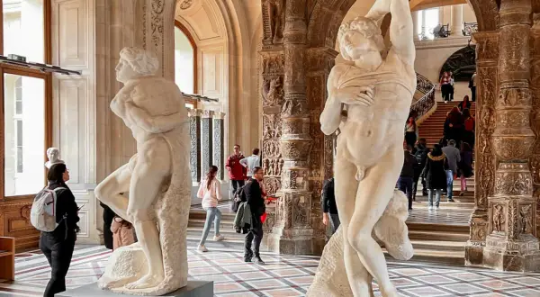 W muzeum, obok siebie stoją dwie antyczne rzeźby. Jedna z nich to Nike z Samotraki, uwieczniona w ruchu.