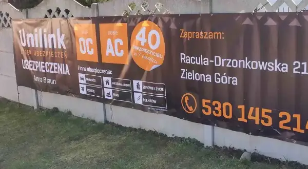 Baner reklamowy agencji ubezpieczeniowej Unilink w Zielonej Górze z informacjami o ofercie i kontaktem.