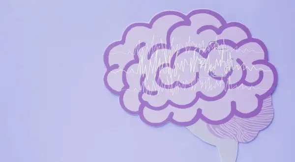 Fioletowy mózg z wykresami fal mózgowych, symbolizujący zdrowie psychiczne definicja.