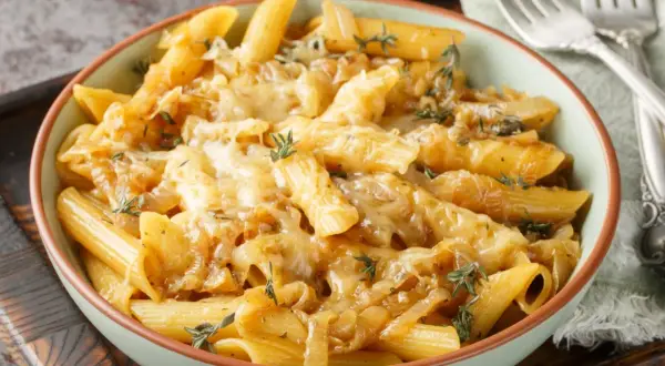 Penne z karmelizowaną cebulą i serem, idealne jako jaki sos do makaronu z warzywami.