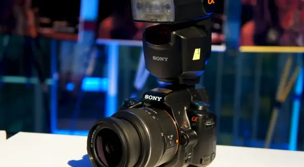 A Sony a37 camera with a flash unit attached, ready to capture any moment.