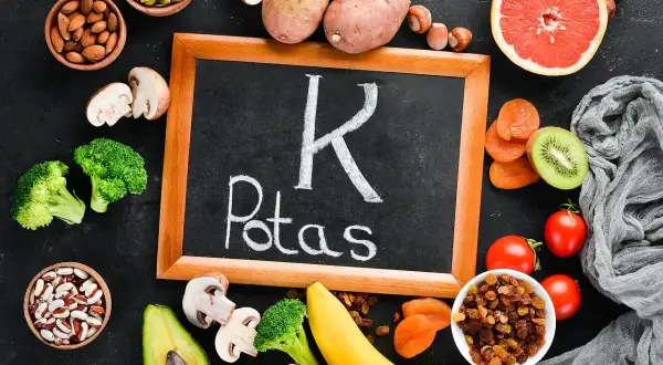 Potas to kluczowy pierwiastek, którego niedobór może być groźny. Na zdjęciu produkty bogate w potas: ziemniaki, banany, awokado, brokuły, pomidory, suszone morele, rodzynki, orzechy, migdały, pestki dyni.