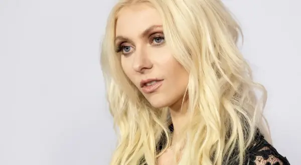 Taylor Momsen, wokalistka The Pretty Reckless, z blond włosami i niebieskimi oczami, wygląda jakby właśnie wyszła na scenę w Warszawie.